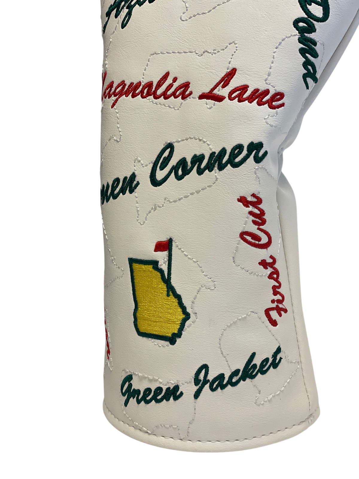 The Birdie Workshop white faux leather golf driver cover with embroidered Masters-inspired tournament text and icons.